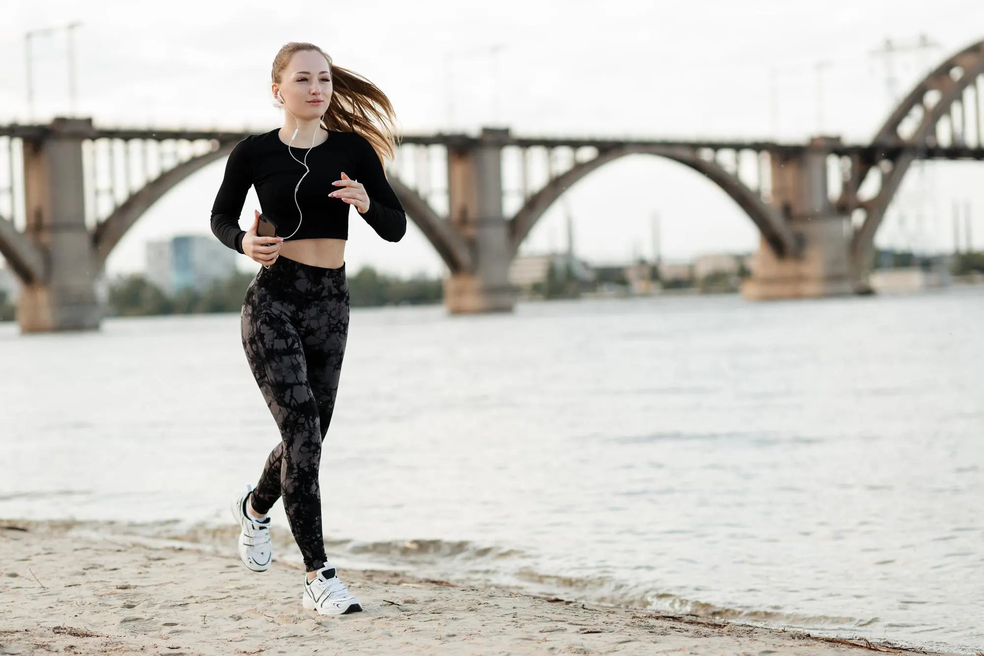 girl jogging along the beach