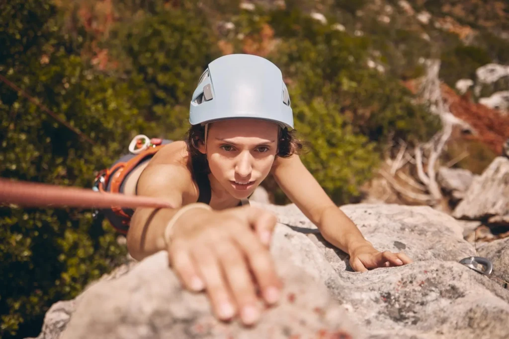 Rock climbing female demonstrating her grip strength.